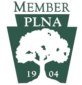 PLNA member logo with a tree silhouette and the year 1904.